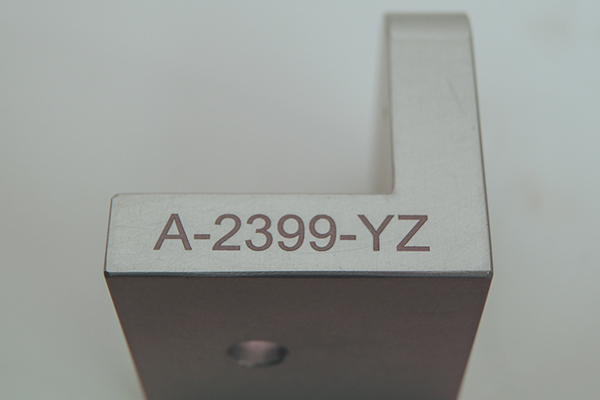 A Machine Part with a clean crisp part number that was created with a laser marker